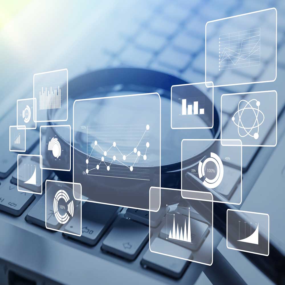 A magnifying glass lies on a computer keyboard, with transparent screens displaying data charts and graphs overlaid, symbolizing digital research and analysis—an approach often used by a Surrey SEO Agency.